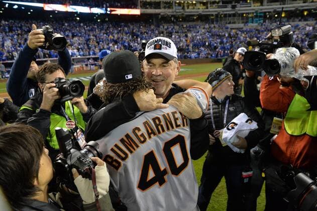 San Francisco Giants pitcher and World Series MVP Madison Bumgarner hugs giants manager Bruce Bochy after the final out against the Kansas City Royals in game 7 of the World Series at Kauffman Stadium in Kansas City, Missouri on October 29, 2014. San Francisco wins the World Series defeating Kansas City 3-2.  KCP2014102985