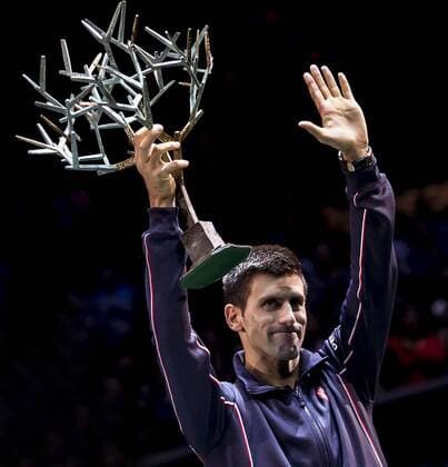 (141103) -- PARIS, Nov. 2, 2014 -- Novak Djokovic of Serbia holds up the trophy during the awarding ceremony after the men s singles final match at the ATP Tennis Herren World Tour Masters 1000 indoor tennis tournament at the Bercy Palais-Omnisport in Paris, France, Nov. 2, 2014. ChenxXiaowei 