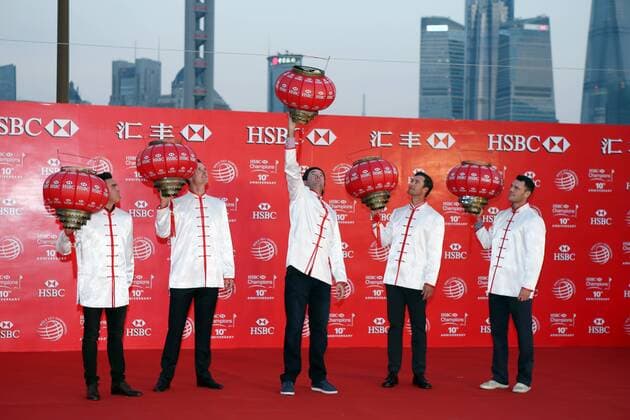Bubba Watson of the United States, center, dressed in Chinese folk costume tangzhuang, hangs a lantern at the opening ceremony of the WGC HSBC Champions golf tournament on the Bund in Shanghai, China, 4 November 2014. Golfers tee off HSBC Champions golf tournament in Shanghai  20141104_34392