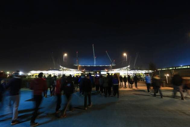 Fans make their way to the Eithad stadium - Manchester City EDITORIAL USE ONLY. No use with unauthorised audio, video, data, fixture lists, club league logos or live services. Online in-match use limited to 120 images, no video emulation. No use in betting, games or single club league player publications.