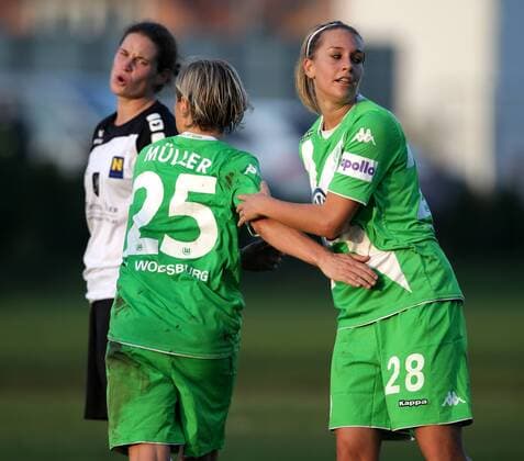 SOCCER - CL, Neulengbach vs Wolfsburg NEULENGBACH,AUSTRIA,09.NOV.14 - SOCCER - UEFA Champions League, Women, NOESV Neulengbach vs VfL Wolfsburg. Image shows Nina Burger (Neulengbach) and the rejoicing of Martina Mueller and Lena Goessling (Wolfsburg). 
