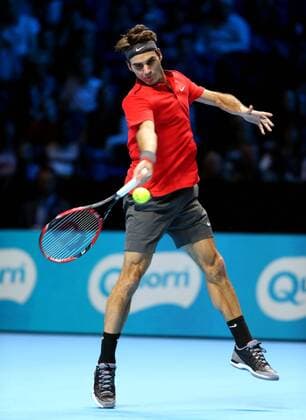 Roger Federer of Switzerland hits a return during the ATP Tennis Herren World Tour Finals Group B match in London, Britain, on Nov. 9, 2014. (SP)BRITAIN-LONDON-TENNIS-ATP WORLD TOUR FINALS-FEDERER VS RAONIC HanxYan 