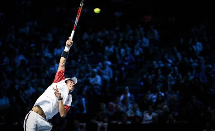 Kei Nishikori of Japan serves during the ATP Tennis Herren World Tour Finals Group B match in London, Britain, on Nov. 9, 2014. (SP)BRITAIN-LONDON-TENNIS-ATP WORLD TOUR FINALS TangxShi 