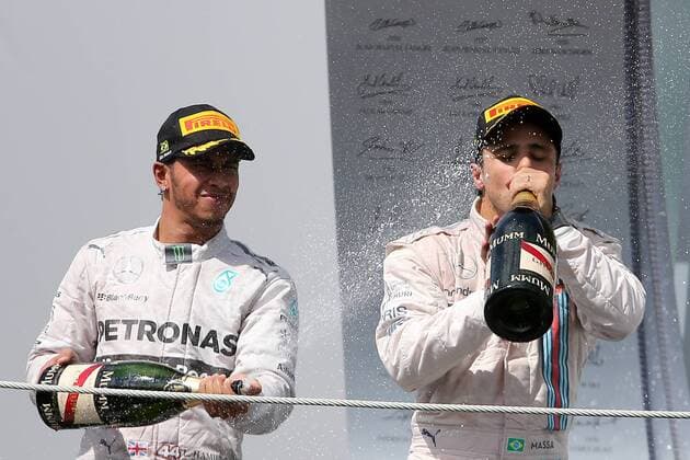 Mercedes driver Lewis Hamilton (L) sprays champagne at the awarding ceremony after the Brazilian Formula One Grand Prix in Sao Paulo, Brazil, on Nov. 9, 2014. (SP)BRAZIL-SAO PAULO-F1-GRAND PRIX XuxZijian 
