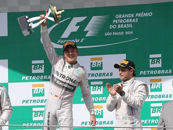 Mercedes driver Nico Rosberg (L) holds his trophy at the awarding ceremony after the Brazilian Formula One Grand Prix in Sao Paulo, Brazil, on Nov. 9, 2014. (SP)BRAZIL-SAO PAULO-F1-GRAND PRIX XuxZijian 