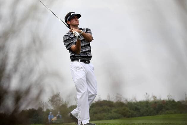 Bubba Watson of the United States plays a shot during the WGC HSBC Champions golf tournament at the Sheshan International Golf Club in Shanghai, China, 9 November 2014. Even in the midst of a meltdown, Bubba Watson never lost hope Sunday (9 November 2014) in the HSBC Champions. He stood on the 16th tee with a two-shot lead. He trudged off the 17th green facing a one-shot deficit behind five players suddenly tied for the lead. And right when it looked as though Watson had blown it, he delivered a finish that not even the creator of ¡°Bubba golf¡± could have imagined. From some 60 yards away in a bunker left of the green on the par-5 18th hole, Watson blasted out of the sand and watched his ball roll 25 feet before it dropped for eagle. Watson was so stunned that his eyes widened and he screamed. He didn¡¯t know what else to do. Moments later, he rolled in a 20-foot birdie putt on the 18th in a playoff to beat Tim Clark and captured his first World Golf Championship. Bubba Watson wins his 1st World Golf Championship in Shanghai  pbu184838_49