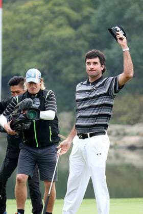 Bubba Watson of the United States, right, waves during the WGC HSBC Champions golf tournament at the Sheshan International Golf Club in Shanghai, China, 9 November 2014. Even in the midst of a meltdown, Bubba Watson never lost hope Sunday (9 November 2014) in the HSBC Champions. He stood on the 16th tee with a two-shot lead. He trudged off the 17th green facing a one-shot deficit behind five players suddenly tied for the lead. And right when it looked as though Watson had blown it, he delivered a finish that not even the creator of ¡°Bubba golf¡± could have imagined. From some 60 yards away in a bunker left of the green on the par-5 18th hole, Watson blasted out of the sand and watched his ball roll 25 feet before it dropped for eagle. Watson was so stunned that his eyes widened and he screamed. He didn¡¯t know what else to do. Moments later, he rolled in a 20-foot birdie putt on the 18th in a playoff to beat Tim Clark and captured his first World Golf Championship. Bubba Watson wins his 1st World Golf Championship in Shanghai  pbu184838_63