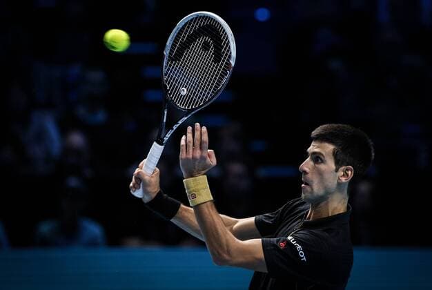 LONDON, Nov. 12, 2014 -- Novak Djokovic of Serbia returns the ball during the ATP Tennis Herren World Tour Finals Group match in London, Britain, on Nov. 12, 2014. TangxShi 