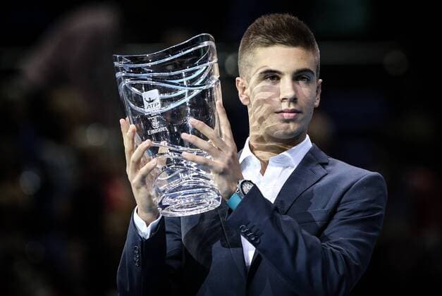 LONDON, Nov. 12, 2014 -- Borna Coric of Croatia poses for pictures after winning the ATP Tennis Herren Star of Tomorrow Award in the ATP Tennis Herren World Tour Finals in London, Britain, on Nov. 12, 2014. TangxShi 