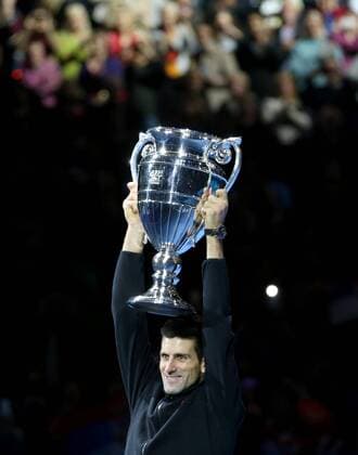 Novak Djokovic of Serbia poses with the trophy after the ATP Tennis Herren World Tour Finals Group match in London, Britain, on Nov. 14, 2014. Djokovic clinch the year-end No. 1 Emirates ATP Tennis Herren Ranking for a third time. ) (SP)BRITAIN-LONDON-TENNIS-ATP WORLD TOUR FINALS-DJOKOVIC-ATP NO. 1 HanxYan 