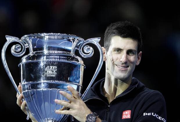 Novak Djokovic of Serbia poses with the trophy after the ATP Tennis Herren World Tour Finals Group match in London, Britain, on Nov. 14, 2014. Djokovic clinch the year-end No. 1 Emirates ATP Tennis Herren Ranking for a third time. ) (SP)BRITAIN-LONDON-TENNIS-ATP WORLD TOUR FINALS-DJOKOVIC-ATP NO. 1 HanxYan 