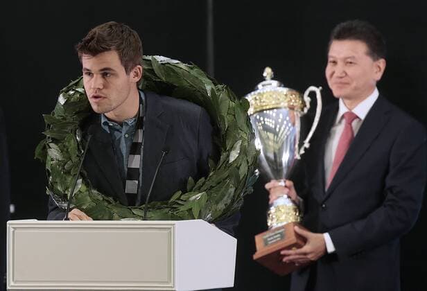 SOCHI, RUSSIA.NOVEMBER 25, 2014. Kirsan Ilyumzhinov, the president of the World Chess Federation (FIDE), right, looks on as chess champion Magnus Carlsen (L-R) of Norway at an awarding ceremony after winning the FIDE World Chess Championship 2014.  premiumd RE155C97