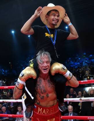 MOSCOW, RUSSIA. NOVEMBER 28, 2014. American actor and boxer Mickey Rourke and his coach Manny Pacquiao celebrate his victory in a boxing match against his compatriot, professional boxer Elliot Seymour, at Luzhniki Stadium. Valery Sharifulin TASS  RE1562DB