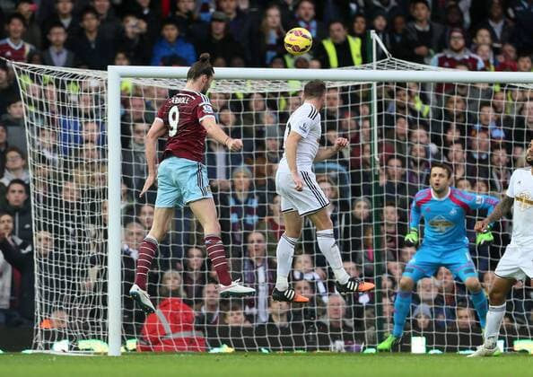 West Ham s Andy Carroll scoring his sides opening goal Barclays Premier League- West Ham United vs Swansea City - Upton Park - England - 7th December 2014 - Picture David Klein Sportimage EDITORIAL USE ONLY. No use with unauthorised audio, video, data, fixture lists, club league logos or live services. Online in-match use limited to 120 images, no video emulation. No use in betting, games or single club league player publications.