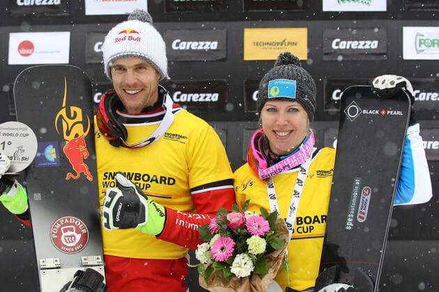 SNOWBOARD - FIS WC Carezza CAREZZA,ITALY,16.DEC.14 - SNOWBOARD - FIS World Cup, parallel giant slalom, award ceremony. Image shows Roland Fischnaller (ITA) and Marion Kreiner (AUT). Keywords: trophy.