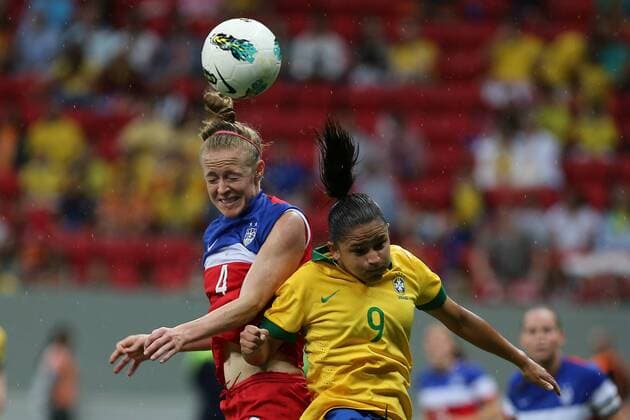 Brazil s player Debora Cristiane de Oliverira (R) heads the ball with Becky Sauerbrunn of the United States during a match between Brazil and the United States of the 2014 International Women s Football Tournament of Brasilia in Brasilia, capital of Brazil, Dec. 21, 2014. Brazil claimed the title after a 0-0 draw over the United States on Sunday. ) (SP)BRAZIL-BRASILIA-WOMEN S FOOTBALL TOURNAMENT-BRAZIL VS USA XuxZijian 