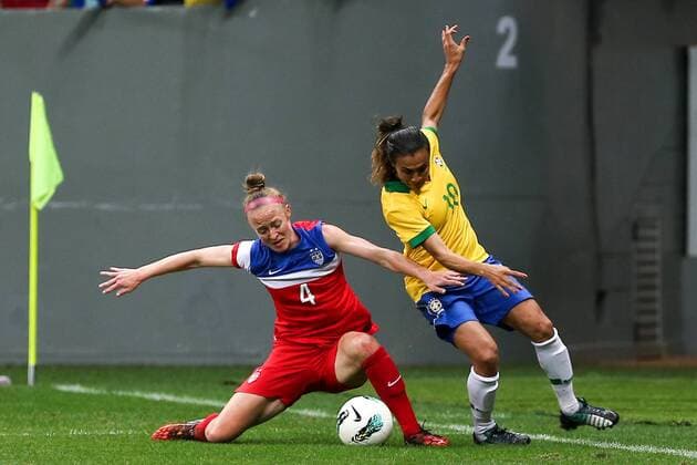 Brazil s player Marta Vieira da Silva (R) vies with Becky Sauerbrunn of the United States during a match between Brazil and the United States of the 2014 International Women s Football Tournament of Brasilia in Brasilia, capital of Brazil, Dec. 21, 2014. Brazil claimed the title after a 0-0 draw over the United States on Sunday. ) (SP)BRAZIL-BRASILIA-WOMEN S FOOTBALL TOURNAMENT-BRAZIL VS USA XuxZijian 