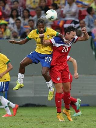 Brazil s player Miraildes Maciel Mota (top) heads the ball with Abby Wambach of the United States during a match between Brazil and the United States of the 2014 International Women s Football Tournament of Brasilia in Brasilia, capital of Brazil, Dec. 21, 2014. Brazil claimed the title after a 0-0 draw over the United States on Sunday. ) (SP)BRAZIL-BRASILIA-WOMEN S FOOTBALL TOURNAMENT-BRAZIL VS USA XuxZijian 