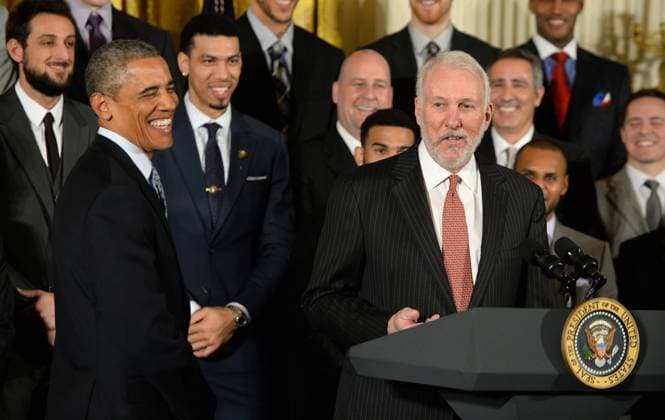 U.S. President Barack Obama smiles after a remark by San Antonio Spurs coach Gregg Popovich (R) as Obama honors the 2014 NBA Basketball Herren USA Champion Spurs in the East Room of the White House in Washington, DC. on January 12, 2015. The Spurs won their fifth championship.  WAS2015011205 PatxBenic