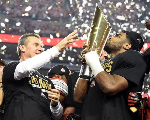 Ohio State Buckeyes head coach Urban Meyer shares the championship trophy with running back Ezekiel Elliott after Ohio State s 42-20 victory over Oregon in the College Football Playoff National Championship, in Arlington, Texas on January 12, 2015.  ARL20150112160 IANxHALPERIN