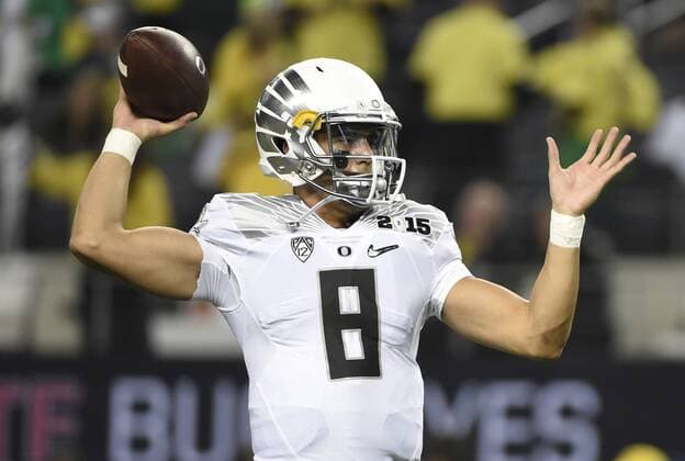 Oregon Ducks quarterback Marcus Mariota warms up on the field before the game against the Ohio State Buckeyes at the College Football Playoff National Championship, in Arlington, Texas on January 12, 2015.  DAL20150112508 KEVINxDIETSCH