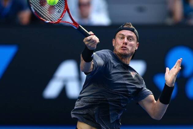 Lleyton Hewitt of Australia returns a shot in their men s singles second round match of the 2015 Australian Open tennis tournament in Melbourne, Victoria, Australia, 22 January 2015.  20150122_32480