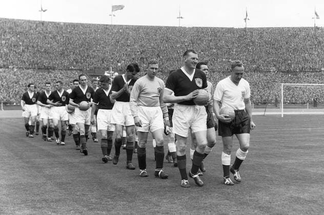 Football - 1957 British Home Championship - England 2 Scotland 1 The two captains, England s Billy Wright and Scotland s George Young, lead their teams out at Wembley. 06 04 1957 