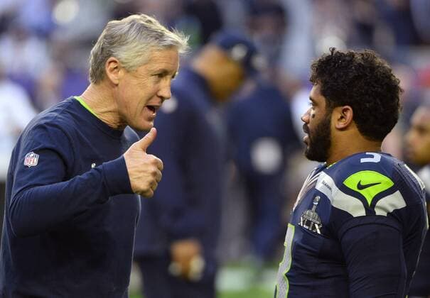 Seattle Seahawks head coach Pete Carroll greets quarterback Russell Wilson (3) during pregame activities of Super Bowl XLIX at University of Phoenix Stadium in Glendale, Arizona, February 1, 2015.  SBP20150201609 DAVIDxTULIS