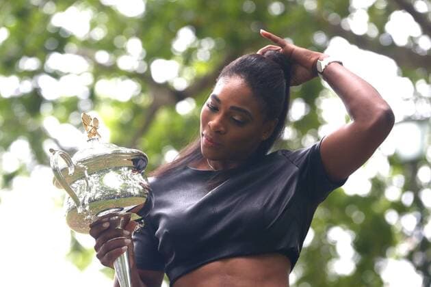 Serena Williams of the United States poses with the Daphne Akhurst Memorial Cup during a photocall at The Royal Exhibition Building in Carlton Gardens Australian Open trophy in Carlton Gardens  20150201_30343