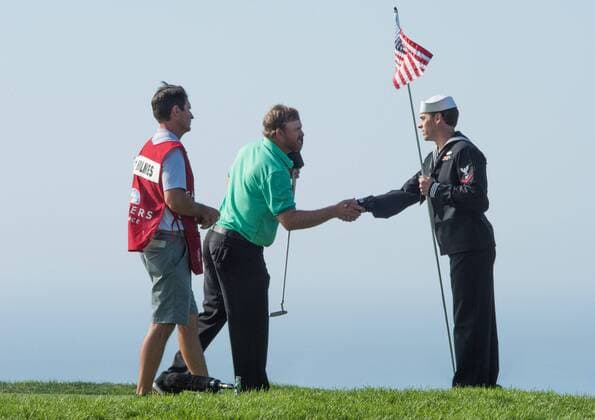 Feb. 8, 2015 - Torery Pines, California, USA - J.B. Holmes and his caddy thank the color guard on the 14th hole during the final round of the Farmers Insurance Open at Torrey Pines Golf Course on February 8, 2015 in San Diego, California. Farmers Insurance Open - Third Round - ZUMAg139