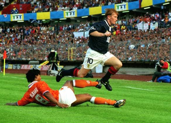 Football - 1992 European Championships - Group Two: Netherlands 1 Scotland 0 Scotland s Stuart McCall jumps a tackle from Holland s Frank Rijkaard at the Ullevi, Gothenburg, Sweden. 12 06 1992 