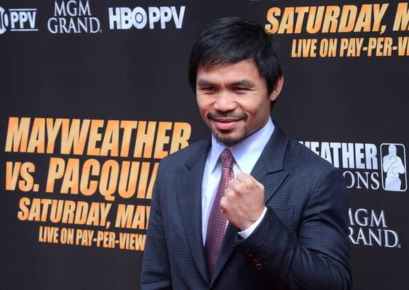 Manny Pacquiao of the Philippines arrives on the red carpet prior to a news conference promoting his upcoming boxing match in Los Angeles on March 11, 2015. The fight is set for May 2nd in Las Vegas.  LAP2015031133 JIMxRUYMEN