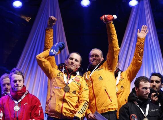 BIATHLON - IBU WC Kontiolahti 2015 KONTIOLAHTI,FINLAND,14.MAR.15 - BIATHLON - IBU World Championships, relay 4x7,5km, men, Medal Plaza, award ceremony. Image shows Erik Lesser and Daniel Böhm (GER).