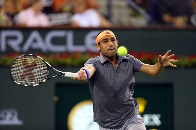 14 March, 2015 : Marcos Baghdatis of Cyprus returns a shot against Novak Djokovic of Serbia during the BNP Paribas Open at Indian Wells Tennis Garden in Indian Wells, California.Charles Baus CSM TENNIS 2015: BNP Paribas Open MAR 14 - ZUMAcb8_
