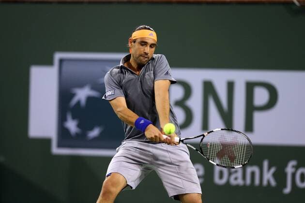 14 March, 2015 : Marcos Baghdatis of Cyprus returns a shot against Novak Djokovic of Serbia during the BNP Paribas Open at Indian Wells Tennis Garden in Indian Wells, California.Charles Baus CSM TENNIS 2015: BNP Paribas Open MAR 14 - ZUMAcb8_