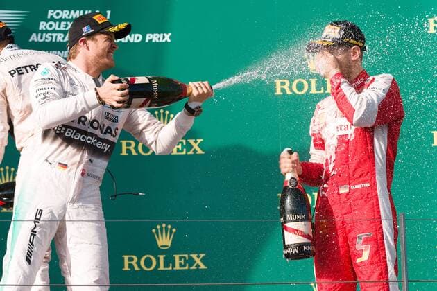 March 15, 2015: Nico Rosberg (DEU) 6 (2nd) and Sebastian Vettel (DEU) 5 (3rd) spray champagne on the podium at the 2015 Australian Formula One Grand Prix at Albert Park, Melbourne, Australia. Sydney Low Cal Media Formula One 2015: Australia MAR 15 - ZUMAc04_