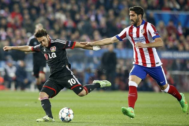 Atletico de Madrid s Raul Garcia (r) and Bayer 04 Leverkusen s Hakan Calhanoglu during Champions League 2014 2015 match.March 17,2015.  (20150301769)