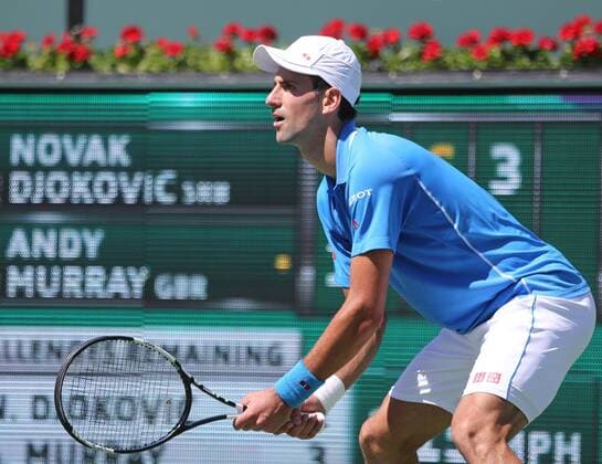 Novak Djokovic of Serbia awaits a serve during his men s semifinal match at the BNP Paribas Open in Indian Wells, California on March 21, 2015.  IDW20150321714 DAVIDxSILPA