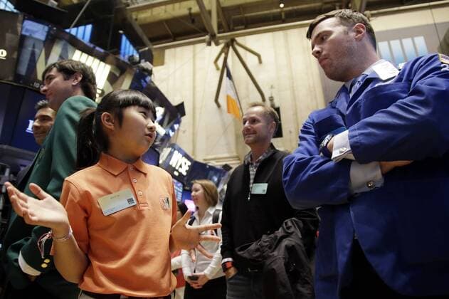 Ten-Year-Old Drive, Chip & Putt Champion Kelly Xu stands on the floor of the NYSE before the closing bell at the New York Stock Exchange on Wall Street in New York City on March 24, 2015. Their appearance at the NYSE is to celebrate Bubba Watson s defense of his 2014 Masters title just two weeks later and KellyÕs defense of her Drive, Chip and Putt title at Augusta National the Sunday before the Masters Tournament.  NYP20150324104 JOHNxANGELILLO