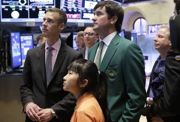 Defending Masters Champion Bubba Watson and 10-Year-Old Drive, Chip & Putt Champion Kelly Xu stand on the floor of the NYSE before the closing bell at the New York Stock Exchange on Wall Street in New York City on March 24, 2015. Their appearance at the NYSE is to celebrate Bubba s defense of his 2014 Masters title just two weeks later and Kelly s defense of her Drive, Chip and Putt title at Augusta National the Sunday before the Masters Tournament.  NYP20150324106 JOHNxANGELILLO