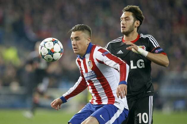 Atletico de Madrid s Jose Maria Gimenez (l) and Bayer 04 Leverkusen s Arda Turan during Champions League 2014 2015 match.March 16,2015.  (201503017123)