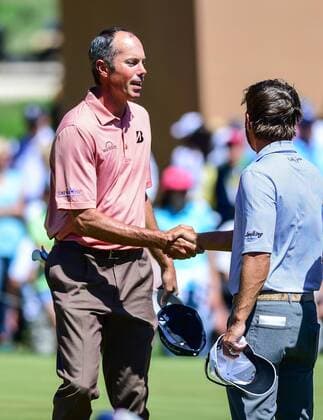 Mar 28, 2015- San Antonio, TX-- Matt Kuchar, left, shakes hands with Kevin Kisner on the 18th green after their third round play of the Valero Texas Open at the AT&T Oaks Course, TPC San Antonio. AUTO: MAR 28 NASCAR Motorsport USA Sprint Cup Series - STP 500 - Practice Icon1503280302015 EDITORIAL USE ONLY