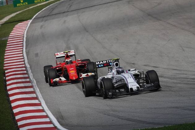 29.03.2015- Race, Valtteri Bottas (FIN) Williams F1 Team FW37 leads Kimi Raikkonen (FIN) Scuderia Ferrari SF15-T Malaysian Grand Prix, Sepang 26 - 29 March 2015 