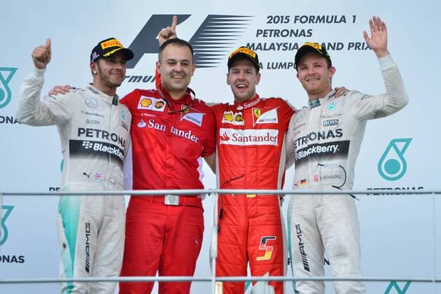 (150329) -- SEPANG, March 29, 2015 -- Ferrari driver Sebastian Vettel (2nd R) of Germany poses with Mercedes driver Nico Rosberg (1st R) of Germany, Mercedes driver Lewis Hamilton (L) of Britain and Diego Ioverno, head of Track Operations and Car Assembly on the podium after the Malaysian Formula One Grand Prix in Sepang, Malaysia, March 29, 2015. ) (SP)MALAYSIA-SEPANG-F1 ChongxVoonxChung 