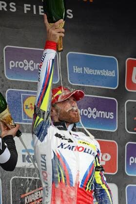 - WEVELGEM, BELGIUM: Italian Luca Paolini of Team Katusha celebrates on the podium with champagne after winning the 77th edition of the Gent-Wevelgem one day cycling race, 239 km from Deinze to Wevelgem, Sunday 29 March 2015. DAVIDxSTOCKMAN  x04595508x