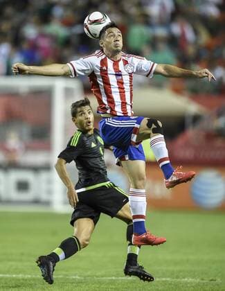 March 31, 2015 - Kansas City, MO, USA - Paraguay s Ivan Piris tried to control a header in front of Mexico s Jonathan Dos Santos (8) in the first half during a friendly on Tuesday, March 31, 2015, at Arrowhead Stadium in Kansas City, Mo. Paraguay vs. Mexico - ZUMAm67_