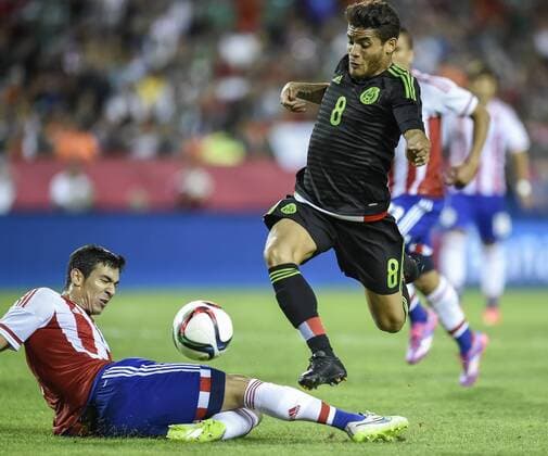 March 31, 2015 - Kansas City, MO, USA - Mexico s Jonathan Dos Santos (8) leaps over the sliding defense of Paraguay s Fabian Balbuena (19) in the first half during a friendly on Tuesday, March 31, 2015, at Arrowhead Stadium in Kansas City, Mo. Paraguay vs. Mexico - ZUMAm67_