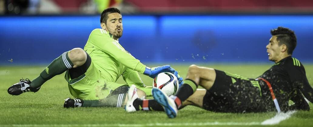 March 31, 2015 - Kansas City, MO, USA - Antony Silva, the goalkeeper for Paraguay, left, makes a sliding save on a challenge by Mexico s Raul Jimenez, right, in the first half during a friendly on Tuesday, March 31, 2015, at Arrowhead Stadium in Kansas City, Mo. Paraguay vs. Mexico - ZUMAm67_