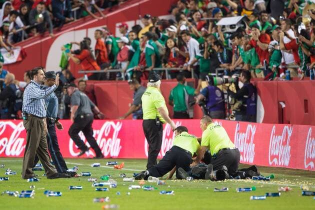 March 31, 2015: Police and security try to subdue fans as they rush the field and throw bottles and trash after the CONCACAF international exhibition soccer game between Mexico and Paraguay at Arrowhead Stadium in Kansas City, Missouri. Mexico won 1-0 SOCCER: MAR 31 Paraguay v Mexico Icon1503310620 EDITORIAL USE ONLY