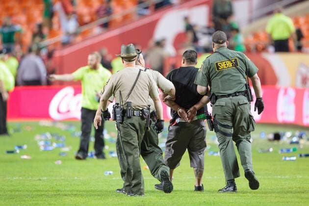 March 31, 2015: Police arrest a fan after many of them rushed the field and starting throwing trash at the police after the CONCACAF international exhibition soccer game between Mexico and Paraguay at Arrowhead Stadium in Kansas City, Missouri. Mexico won 1-0 SOCCER: MAR 31 Paraguay v Mexico Icon1503310648 EDITORIAL USE ONLY